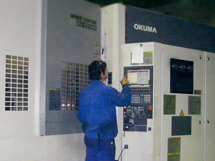 INAMESA operator working on an OKUMA machining centre
